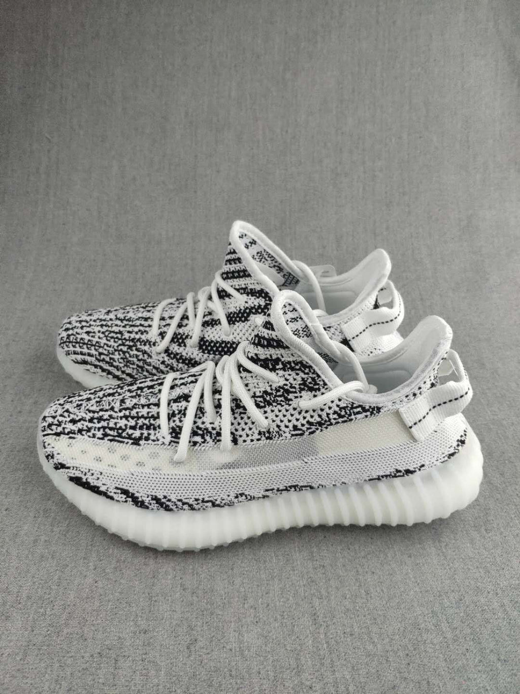 Black and White Yeezy 350 V2 Knit Sneakers - product image from the listing.