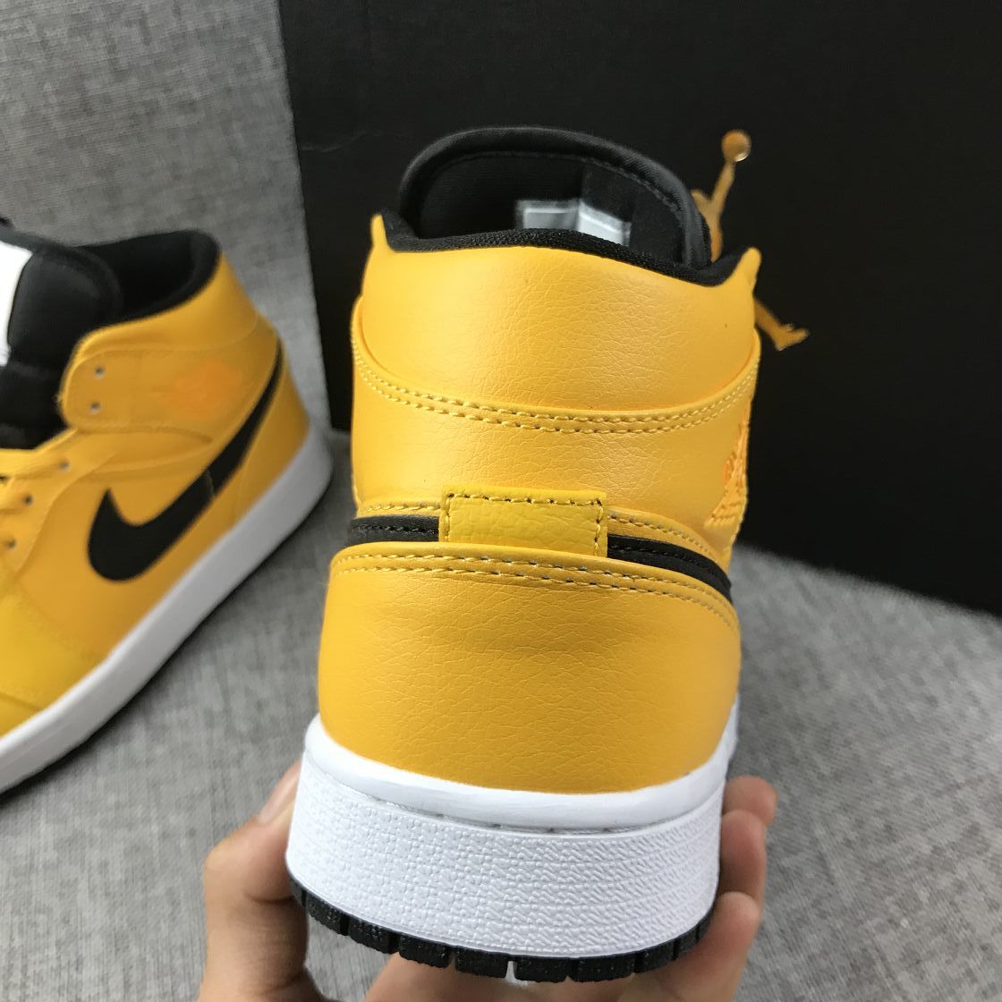Air Jordan 1 Mid Sneakers in University Gold Black White - product image from the listing.
