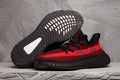 Red and Black Yeezy 350 V2 Knit Sneakers - product image from the listing.