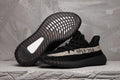 Yeezy 350 V2 Sneakers in Black and Cream Knit - product image from the listing.