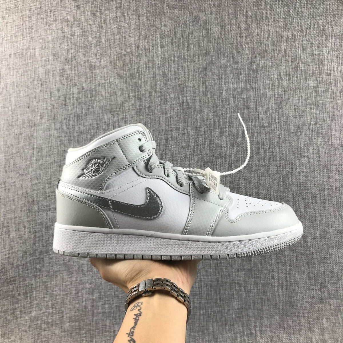 Air Jordan 1 Mid GS White and Silver Sneakers - product image from the listing.