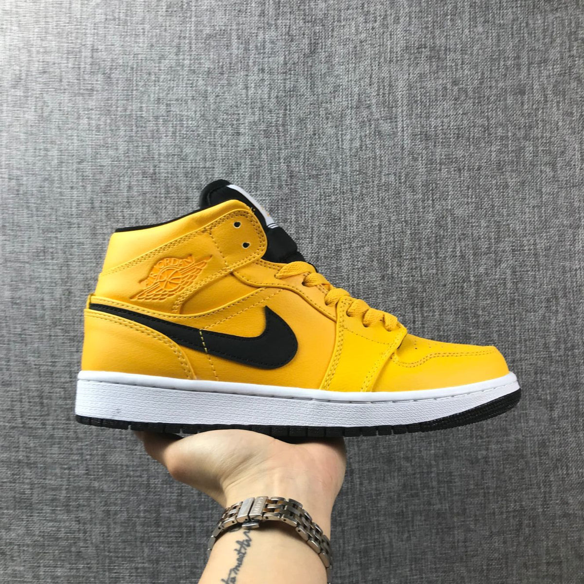 Air Jordan 1 Mid Sneakers in University Gold Black White - product image from the listing.