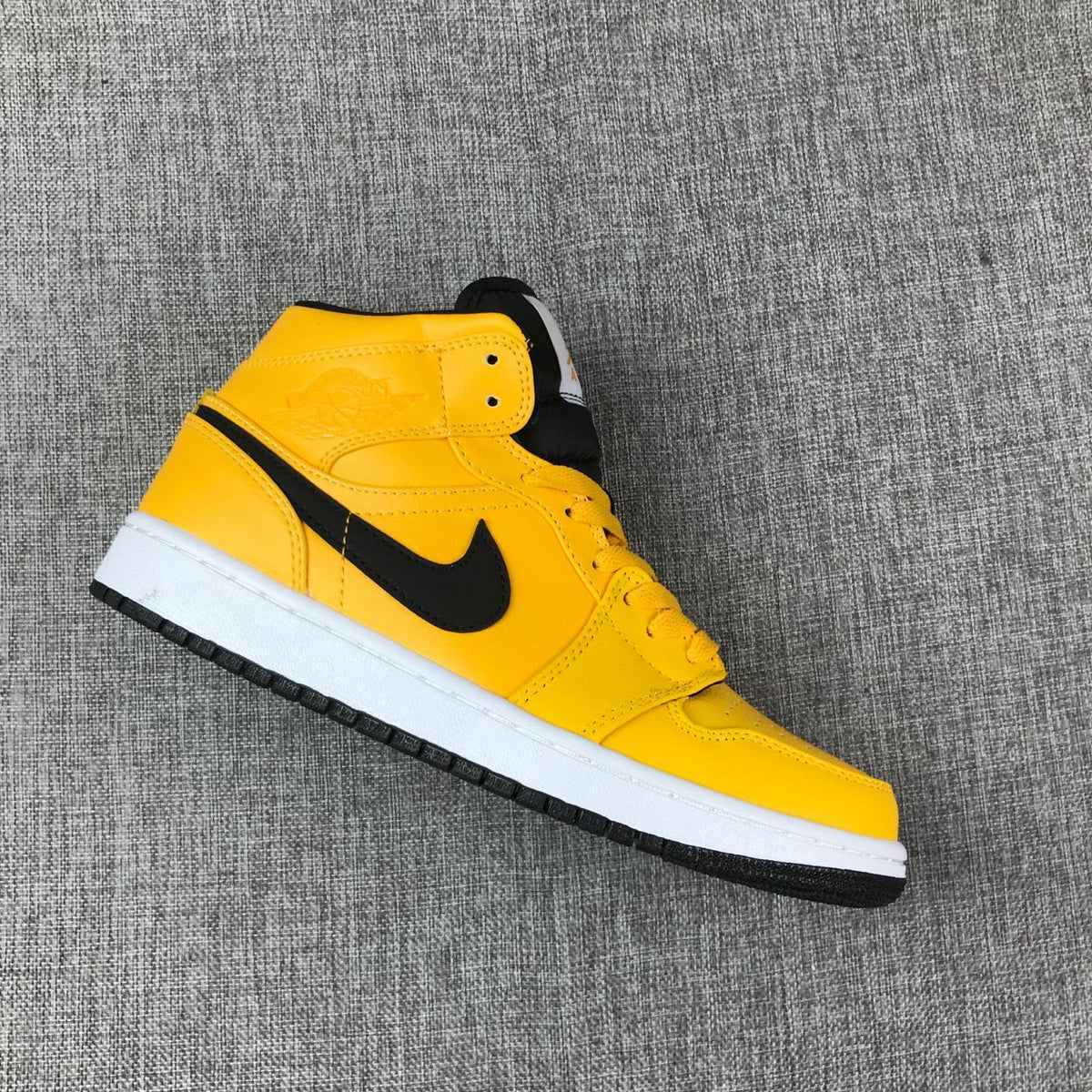 Air Jordan 1 Mid Sneakers in University Gold Black White - product image from the listing.