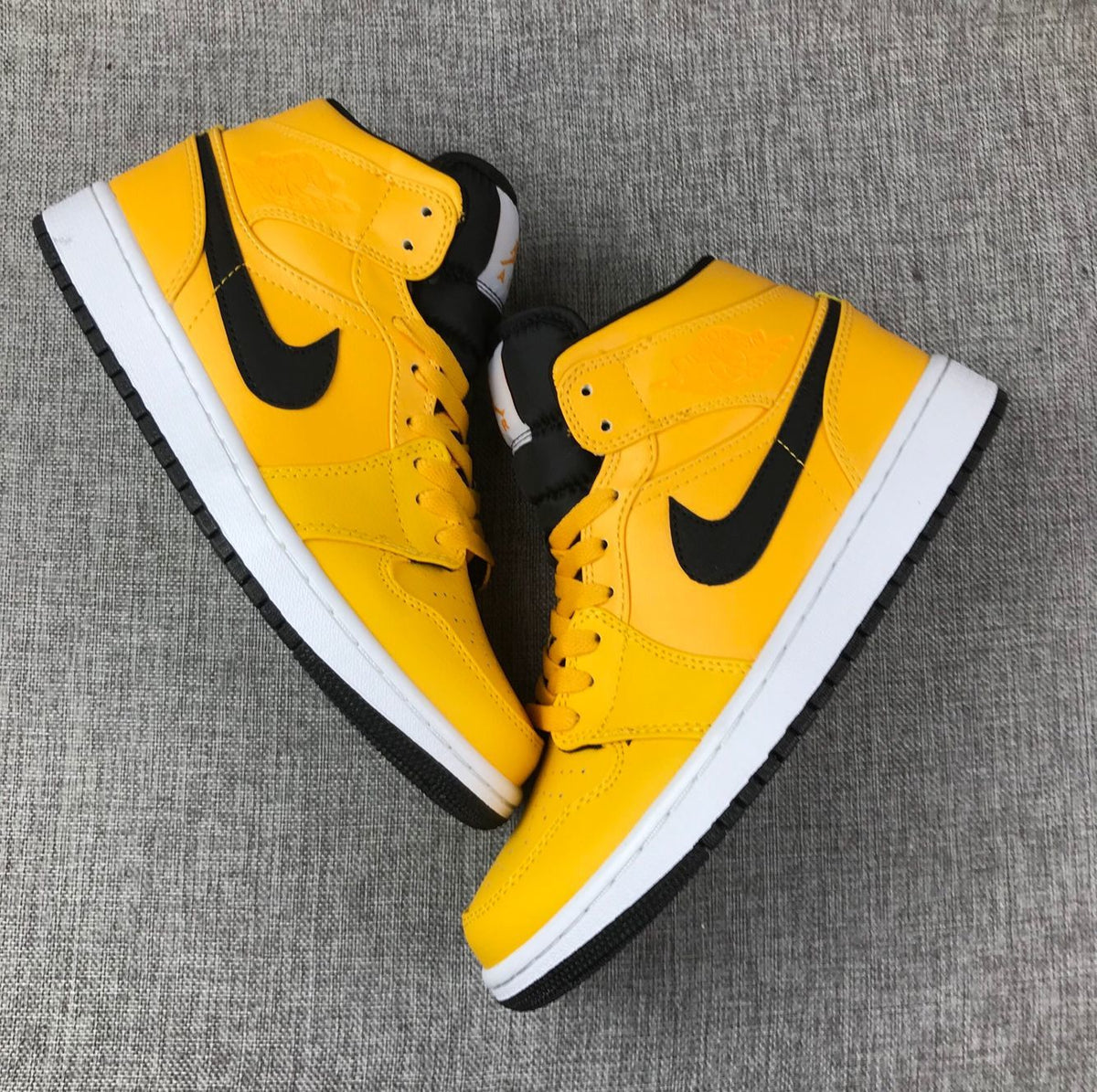 Air Jordan 1 Mid Sneakers in University Gold Black White - product image from the listing.