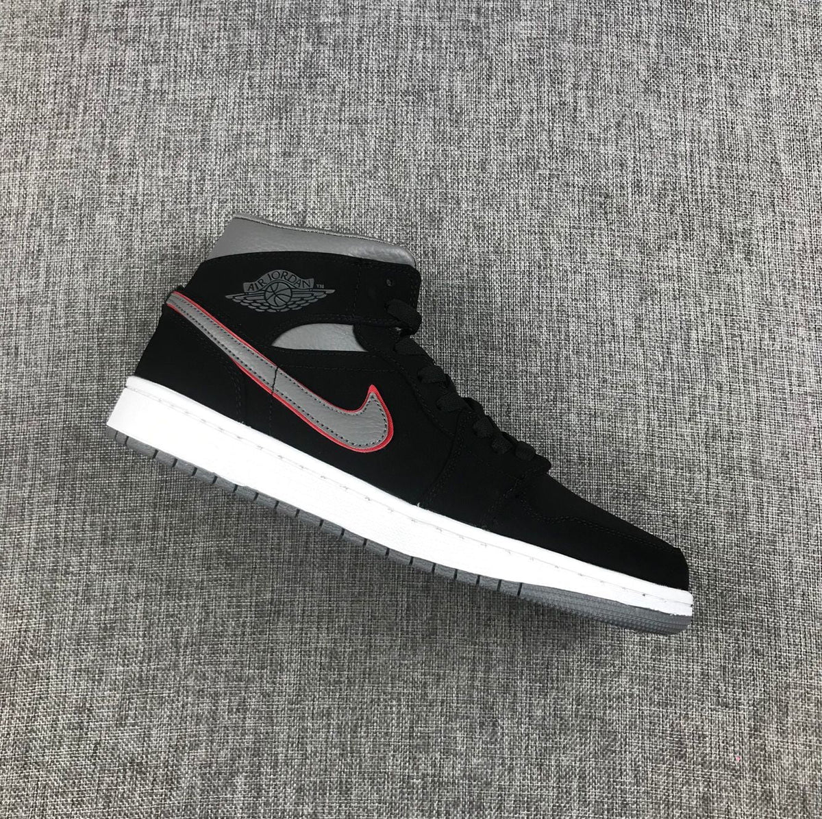 Air Jordan 1 Mid Sneakers in Black Grey Red 554724-060 - product image from the listing.