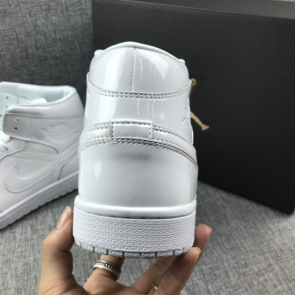 Air Jordan 1 Mid White Patent-Style Sneakers BQ6472-111 - product image from the listing.