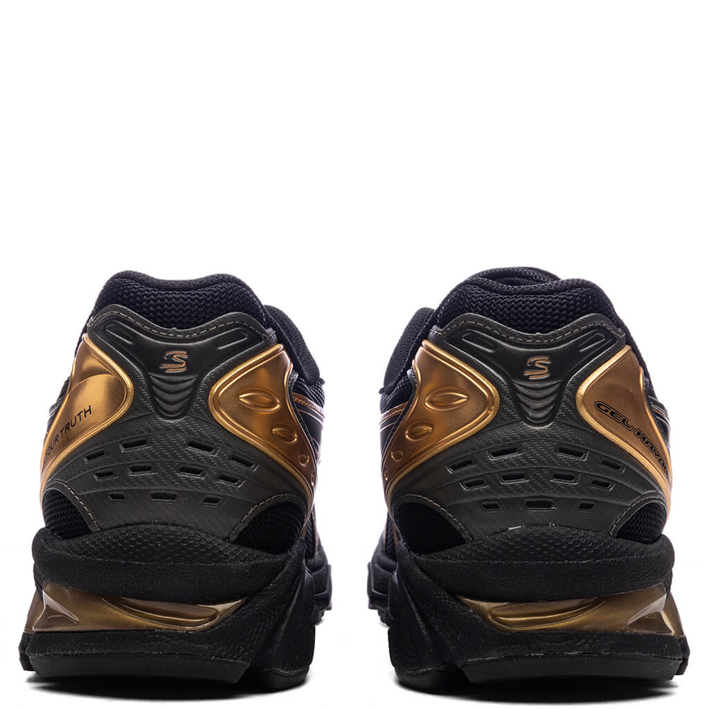 Asics x Ayrton Senna Gel-Kayano 14 in Black/Pure Gold - product image from the listing.