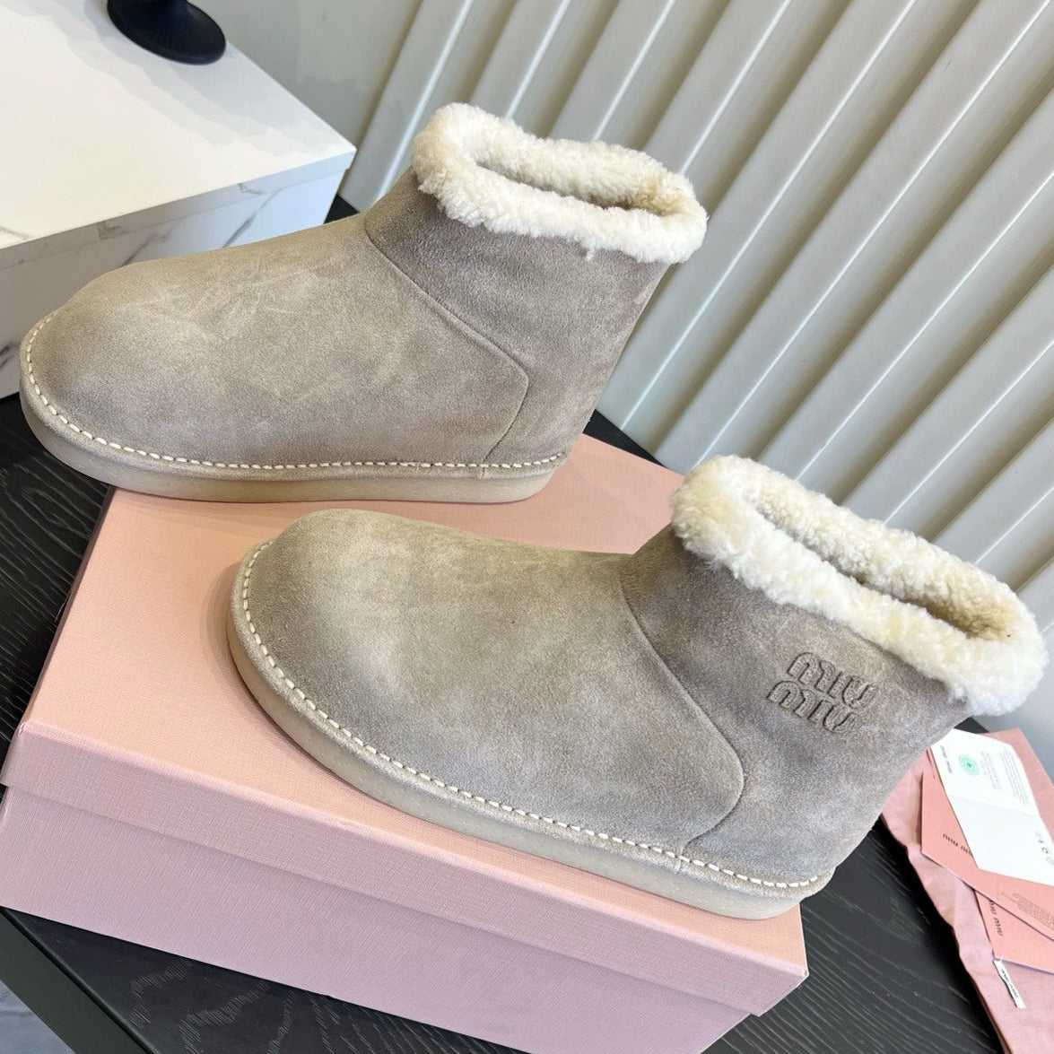 2026 Snow Ankle Boots Suede 977010 by Miu Miu - product image from the listing.